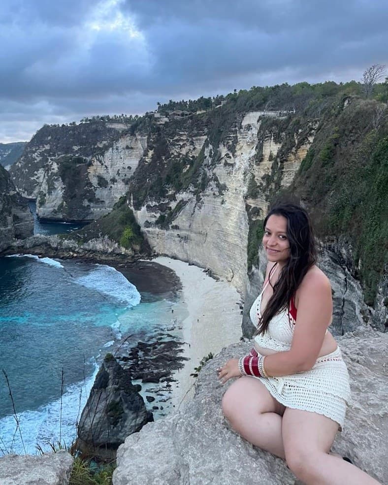 Yashna beside a coastal landscape
