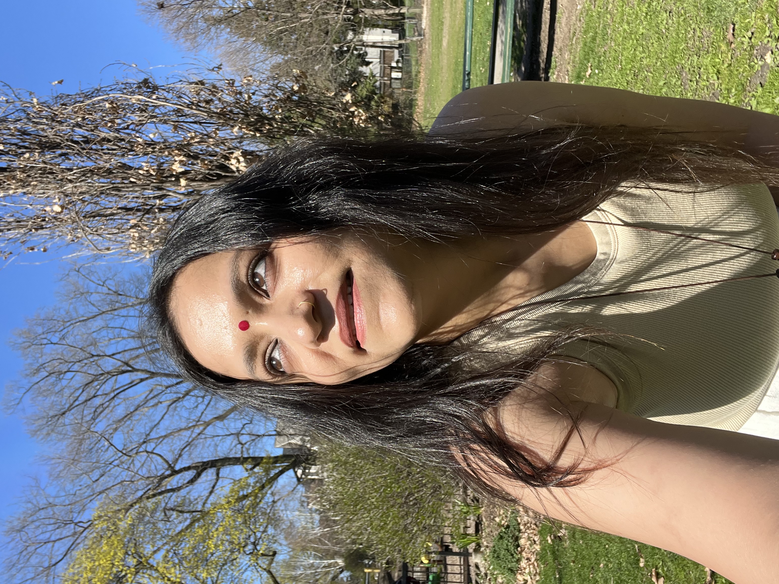 Close portrait of Yashna outdoors, looking toward the camera