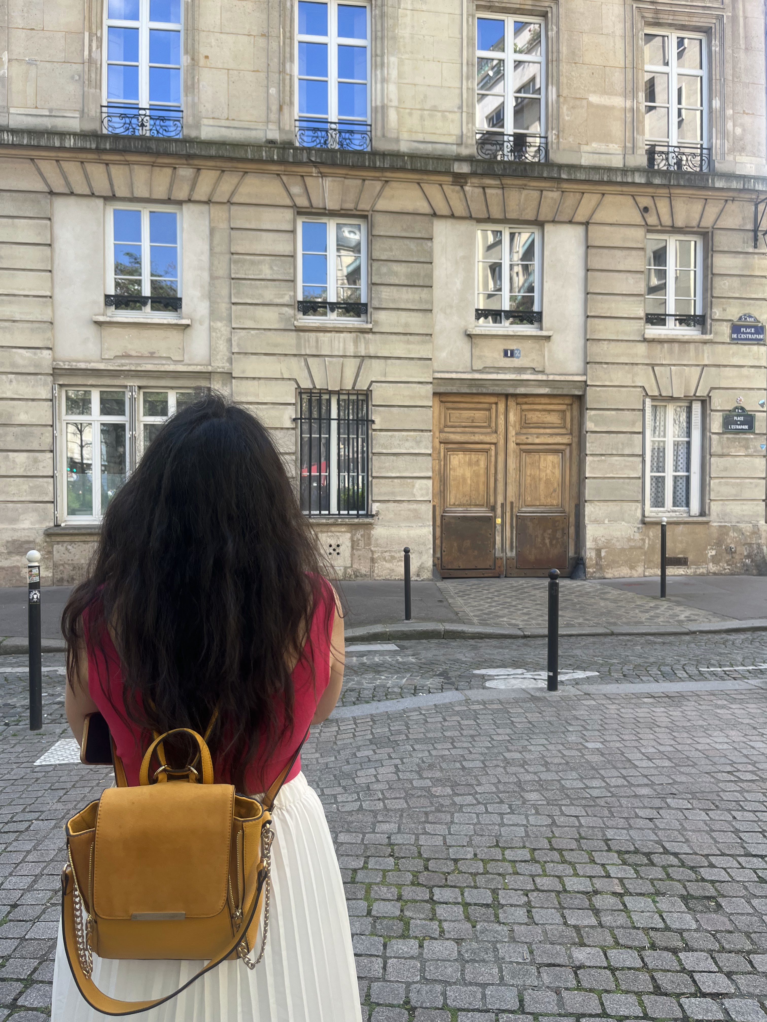 Yashna facing a stone building on a cobbled street